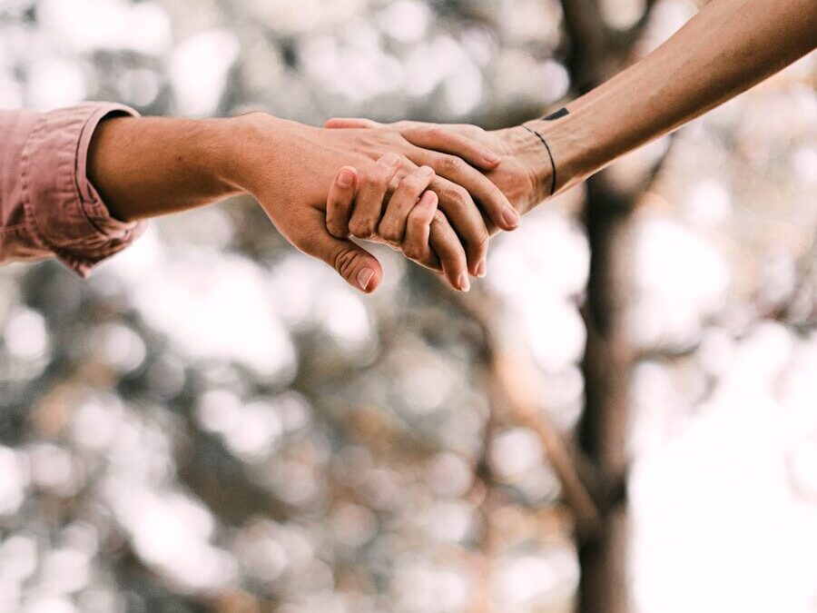 person holding hands with white clouds